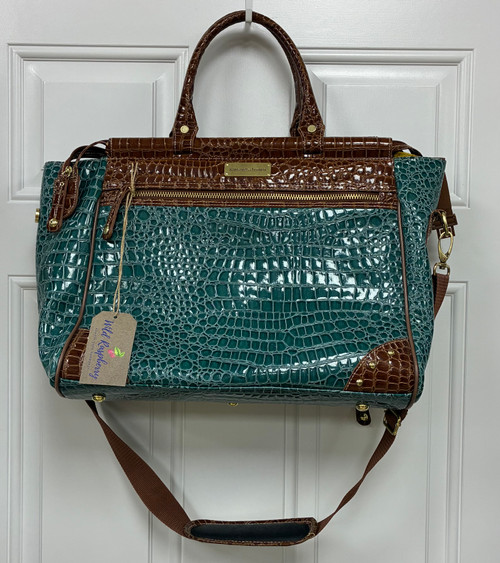 A striking gator-embossed texture in a rich dark teal and brown colorway gives this weekender bag serious statement appeal. Spacious and sturdy, it's the perfect travel companion for a quick getaway or everyday overnight essentials.