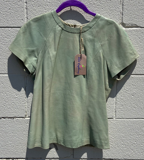 This sage green leather tee blurs the line between fashion and art, offering a sleek, modern silhouette in luxuriously soft leather. A true statement piece that elevates any outfit, the kind of design that feels more like wearing a sculpture than a shirt.