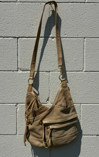Rich, supple leather in a warm tan hue gives this satchel timeless appeal that only gets better with wear. Structured yet relaxed, it features a spacious interior, sturdy top handles, and clean, understated hardware for a look that's polished without trying too hard. A go-to piece that layers effortlessly into any outfit, season after season.