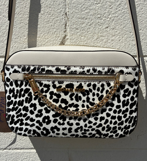 Fierce leopard print takes center stage on this eye-catching satchel, playfully offset by a crisp white and black colorway for a look that's anything but basic. Finished with a sleek gold-tone chain zipper pull and signature MK hardware, this bag adds instant edge to any outfit — from jeans and a tee to your favorite little black dress.