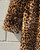 A bold leopard print faux fur maxi coat from designer Dennis Basso. Luxurious texture and eye-catching pattern make this a true statement outerwear piece. Perfect for elevating any winter outfit with a touch of glamour and animal-print edge.