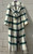 A striking white base with a bold green and black plaid pattern makes this designer maxi coat an instant eye catcher. Luxurious, editorial, and the ultimate statement piece for anyone who loves fashion-forward outerwear!