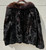 A deep dark brown short fur coat features a striking dark red trim at the neckline for a bold pop of color and texture. Unbranded but beautifully made, perfect for anyone who loves vintage fur with a unique, statement-making detail!
