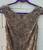 A soft tan/light brown hue is covered edge to edge in tiny hand-sewn beads and sequins, giving this dress a subtle, all-over shimmer. Elegant and versatile, it's perfect for weddings, formal events, or any occasion calling for understated sparkle.