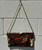 A true retro treasure, this clutch showcases genuine snakeskin texture in a compact, era-defining silhouette. Effortlessly elegant with a hint of old-Hollywood flair, it's the kind of one-of-a-kind piece that instantly elevates any outfit — vintage denim, a slip dress, or your favorite going-out look. A rare collector's find for anyone who loves timeless style with real character.