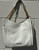 Crisp white leather gives this tote a polished, versatile edge that pairs with absolutely everything. Featuring clean structured lines, sturdy top handles, and signature MK gold-tone hardware, it's roomy enough for work, travel, or daily essentials while staying effortlessly chic. A timeless neutral that never goes out of style.
