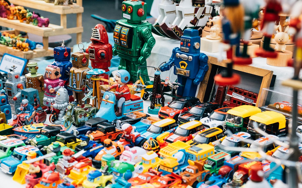 A colourful assortment of collectible toy robots and miniature cars