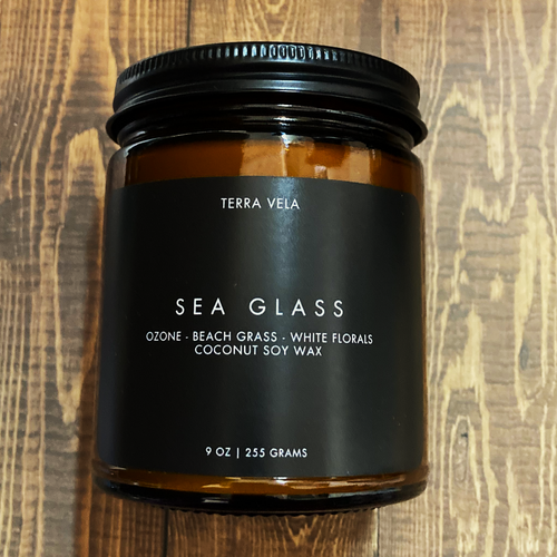 Terra Vela Amber Jar soy wax candle with black lid, burns for up to 50 hours.