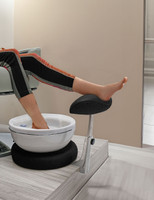Adjustable foot rest with mounting bracket in a salon setting by Belava