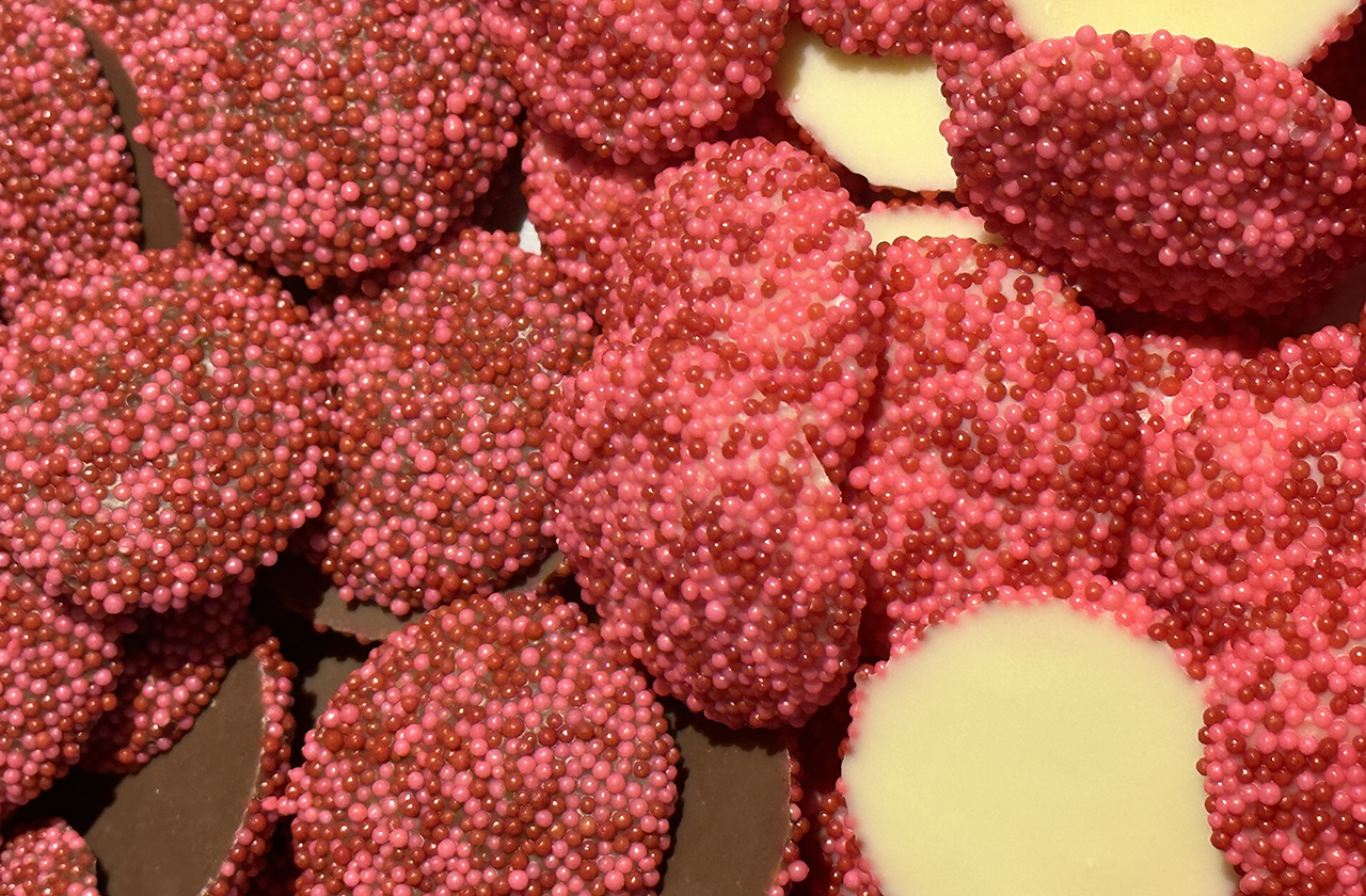 Milk and white chocolate nonpareils with red and pink sprinkles