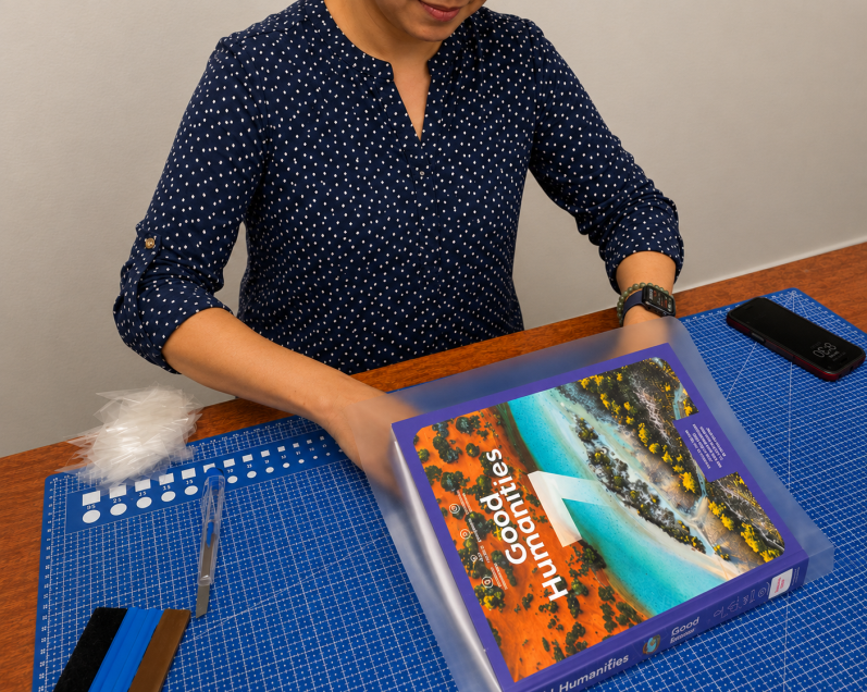 A book being carefully prepared for professional covering