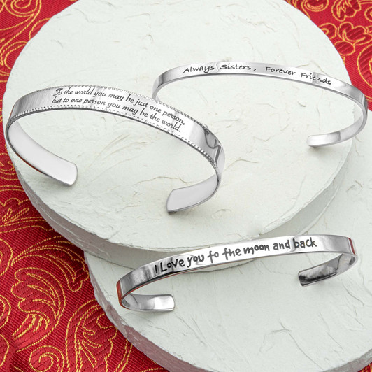 Stainless steel cuff bracelet with engraved words 'I love you to the moon and back'—a symbol of infinite love and cherished connections. Adjustable and crafted with high-quality materials