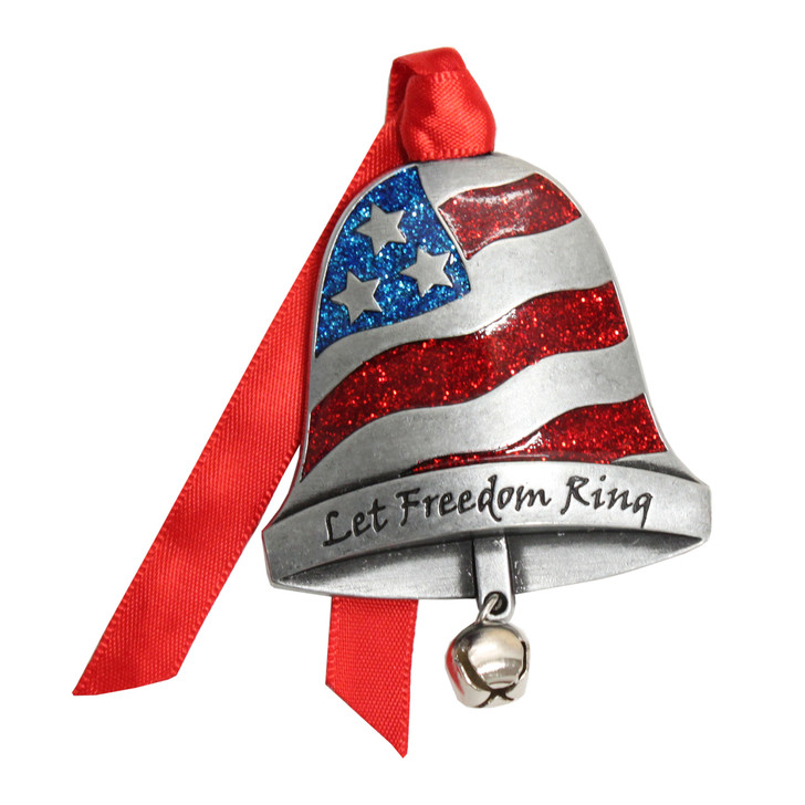 Patriotic pewter bell ornament with red and blue glitter paint depicting the US flag and the message "Let Freedom Ring" engraved on the bottom. Attached jingle bell and ribbon for hanging. Made in America.