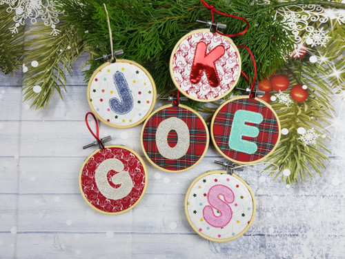 Personalised Capital Letter Ornament Decoration

These are made with a Choice of Fabric that I embroider a Capital Letter on in a A Glitter Fabric of your choice and then mounted in a 3-inch wooden hoop.

The back of the hoop is then covered with felt so that it is neat and tidy, a coloured cord is added so that it is ready to hang up.

Discounts for Multiples what will show in your cart.