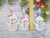 Personalised Snowman Decoration Christmas Tree Hanging Decorations
My snowmen decorations come in 2 sizes:

1: Small is 10cm, 2: Large is 13cm 

I make them from layers of felt with a little padding inside to give them a 3D look, and this makes them cute too.

If you choose female names then the snowman will be finished off with a pink/white bow and a pink scarf to match. The male named snowmen will not have a bow but will also come with a blue scarf.
The font will always be the same, but may look smaller for longer names.