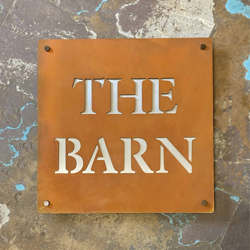 Double layer sign with a Corten steel front layer and stainless steel back layer