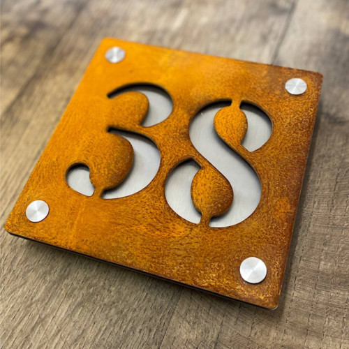 double layer steel house number with a Corten steel front layer and stainless steel backing layer