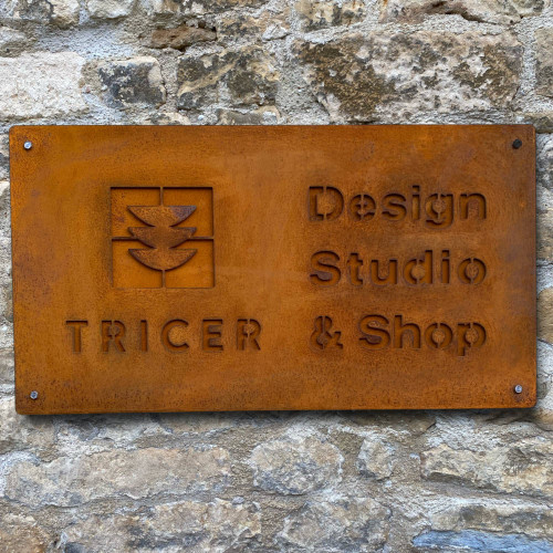 Double layer sign with a Corten steel front layer and Corten steel back layer