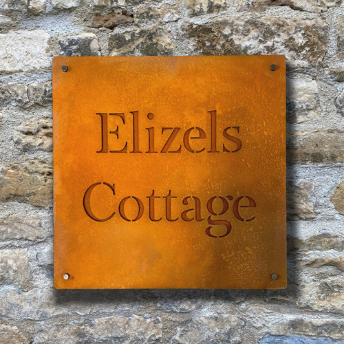 Double layer sign with a Corten steel front layer and Corten steel back layer