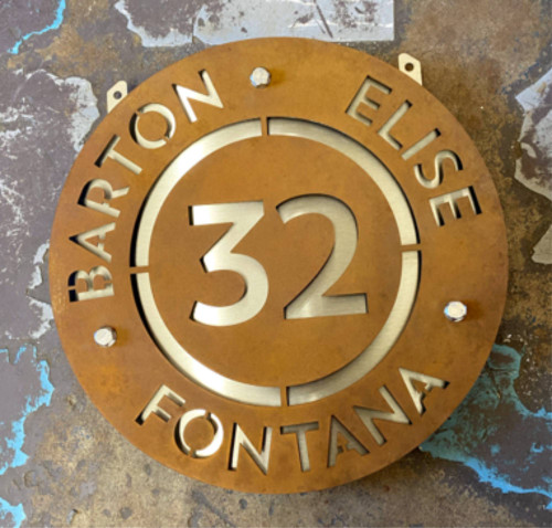 Circular Corten steel projecting sign with stainless steel middle layer