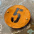 A round Corten house number. Round rusty steel sign - ideal for house numbers.