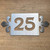 Stainless steel house number sign with fleur-de-lys styling