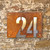 double layer steel house number with a Corten steel front layer and stainless steel backing layer