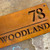 Corten steel house sign, rusty metal house name sign, rusty steel house name and number sign with dividing line between the name and number.