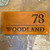 Corten steel house sign, rusty metal house name sign, rusty steel house name and number sign with dividing line between the name and number.