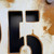 Close up of a painted and distress Corten steel house number