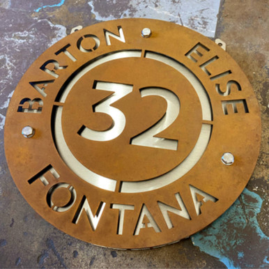 Circular Corten steel projecting sign with stainless steel middle layer