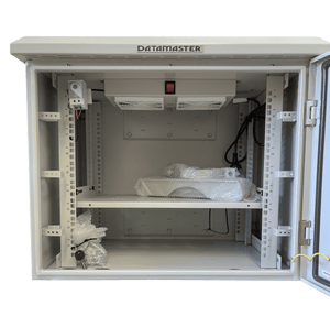 Interior of outdoor IP55 cabinet showing adjustable 19-inch rails and pre-installed shelf
