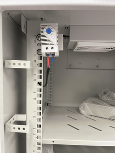 Close-up of cabinet ventilation filters and dual thermostat-controlled fans for temperature regulation