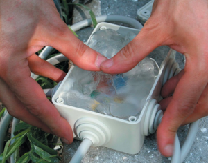 Gemini Gel filling and sealing an outdoor electrical junction box for IP68 waterproof protection