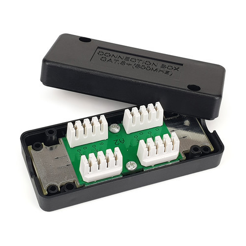 A top-down view of the Cat6 in-line punch-down coupler, showing the open housing and the colour-coded IDC termination blocks inside.
