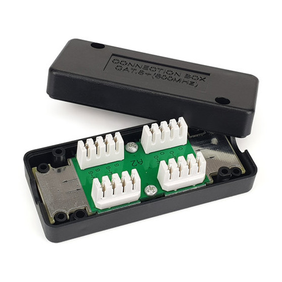 A top-down view of the Cat6 in-line punch-down coupler, showing the open housing and the colour-coded IDC termination blocks inside. A top-down view of the Cat6 in-line punch-down coupler, showing the open housing and the colour-coded IDC termination blocks inside.