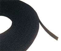 A close-up side profile of the 25m roll of black hook and loop cable tie tape, showing the fabric texture.