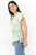 Blusa manga corta en Zafiro Licrado de lunares con escote V cruzado, lazo lateral y manga tulipán
