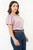 Blusa manga corta en Cupro con mangas abullonadas, escote bote y detalles de pliegues y pespuntes
