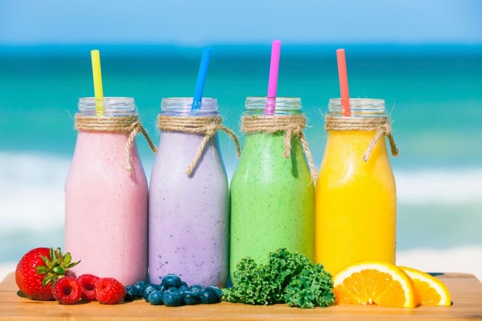 Premium Photo  Colorful smoothie in glass bottles summer fruit smoothies  in jars healthy detox food concept