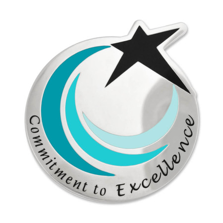 Round lapel pin with a star shape, upper right hand, silver color, says the words commitment to excellence in black enamel - front view