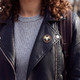 Zodiac pin on a black leather jacket lapel