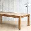 Angled view capturing the detailed edge work of the solid oak tabletop