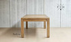 Full-length view from one end of the table, showcasing its 2.5m oak construction