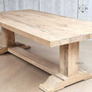 An image capturing the natural wood patterns and grain of the Charlested Oak Dining Table, showcasing its organic beauty