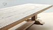 The Charlested Oak Dining Table under muted lighting, accentuating the subtleties of the oak's grain and color