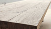 The Charlested Oak Dining Table in a soft shadow, creating a sense of depth and texture in the oak