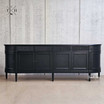 Frontal perspective of the Louis Curved Buffet focusing on the symmetrical arrangement of its grooved drawers, paired with the sleek, modern handles.