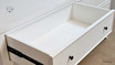 Close-up of the metal drawer runner highlighting the smooth operation and showcasing the hand-carved molding.