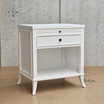 Angled view focusing on the bedside table's white finish